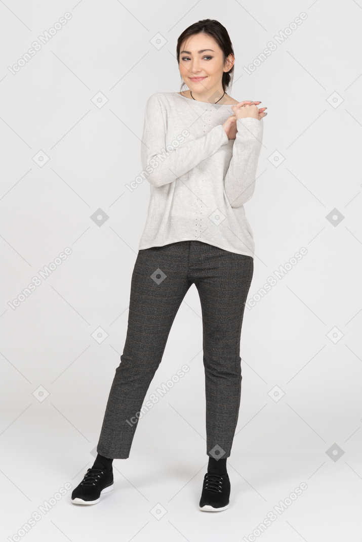 Cheerful caucasian female holding hands together