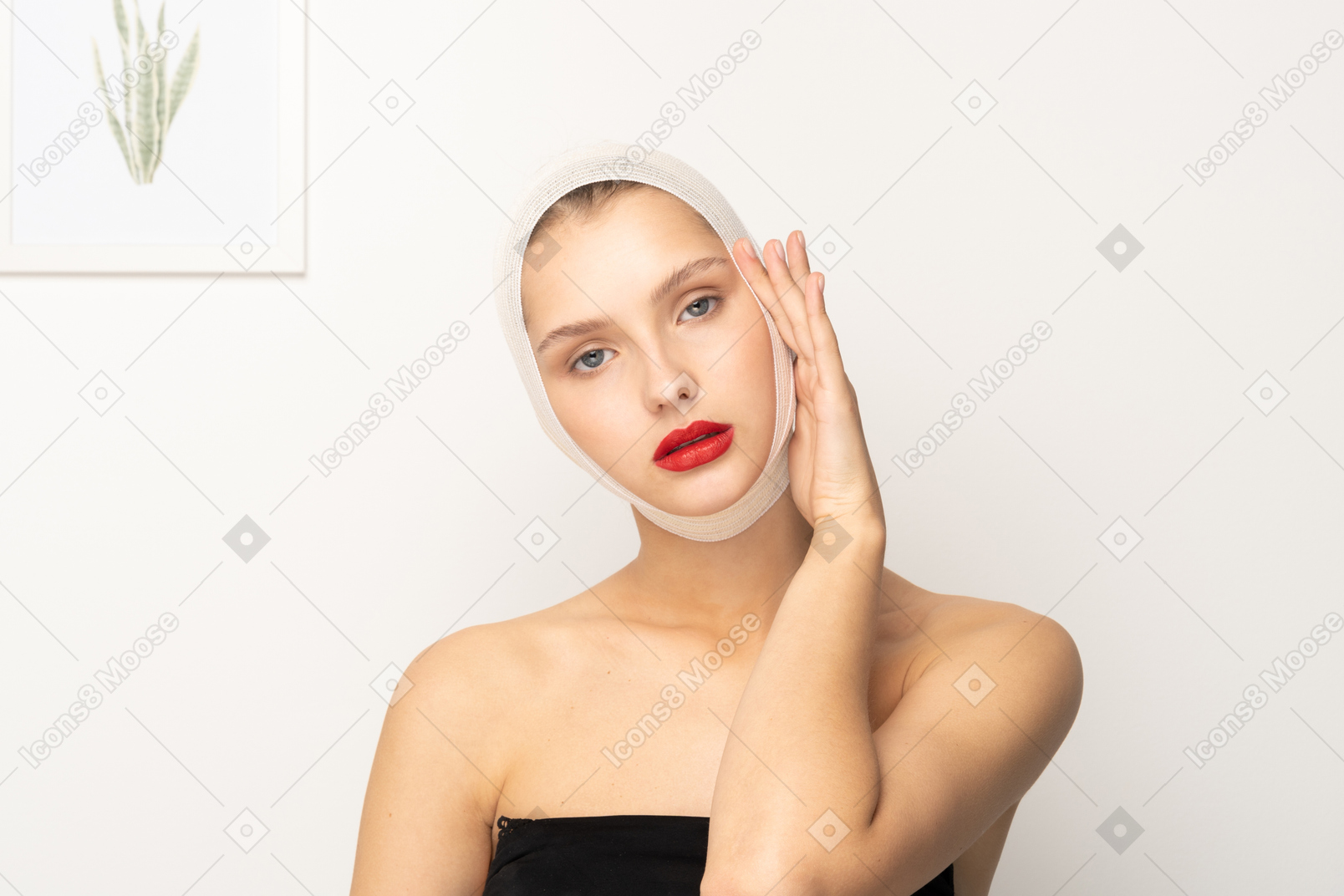 Woman with bandaged head touching side of face