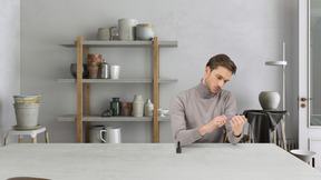 A young man doing manicure in a room