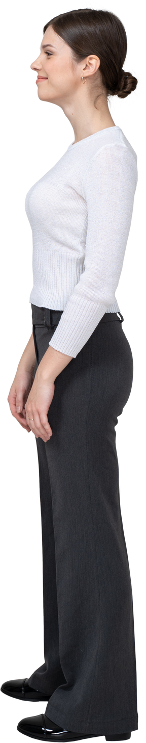 Side view of a pleased young woman in office clothing
