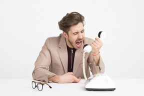 Furious businessman yelling on the phone