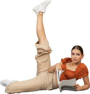 Young woman stretching her leg while holding a book
