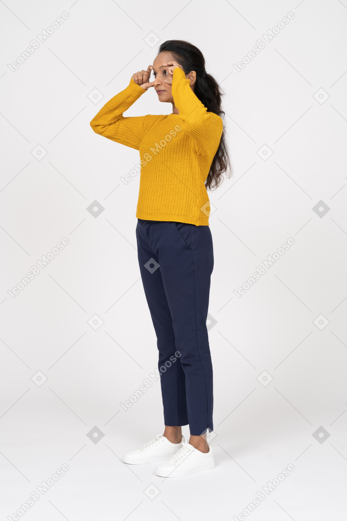 Side view of a girl in casual clothes opening eyes with fingers