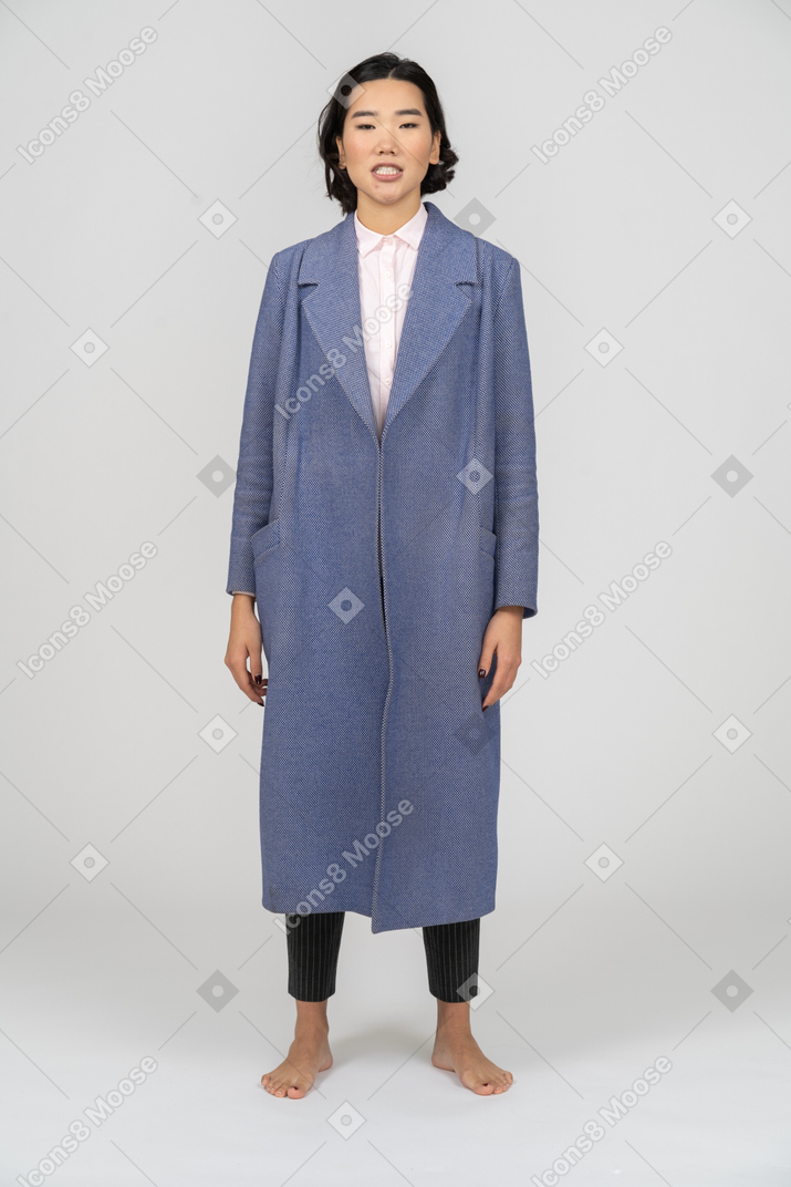 Woman with clenched teeth wearing blue coat