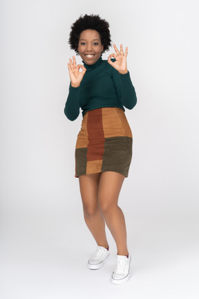 Smiling afro-american girl making ok gesture with both hands