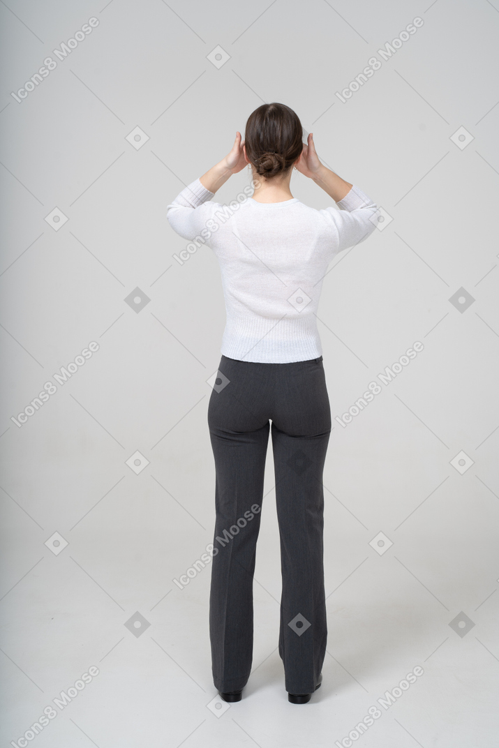 Back view of a woman covering eyes with hands