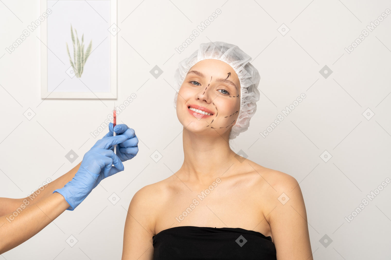 Young woman smiling and gloved hand holding up syringe