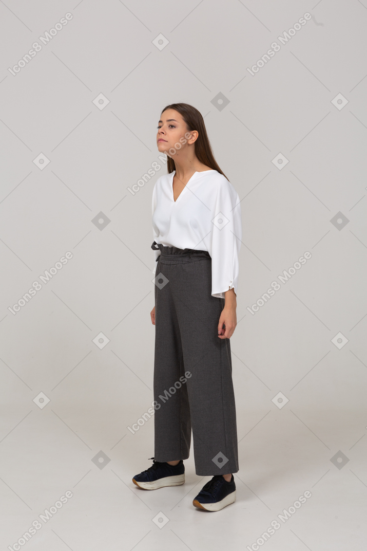 Three-quarter view of a young lady in office clothing outstretching her neck