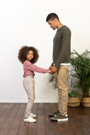 Father and daughter hold hands