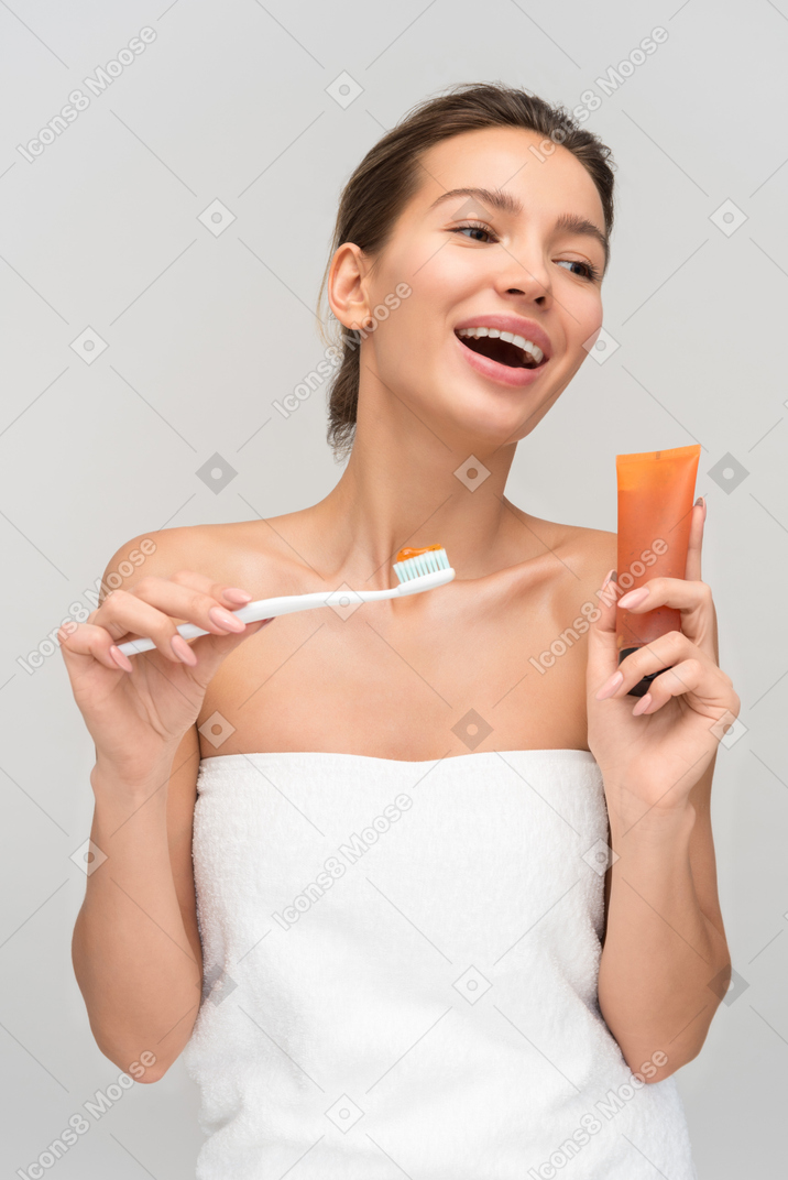 Beautiful young woman is about to clean her teeth