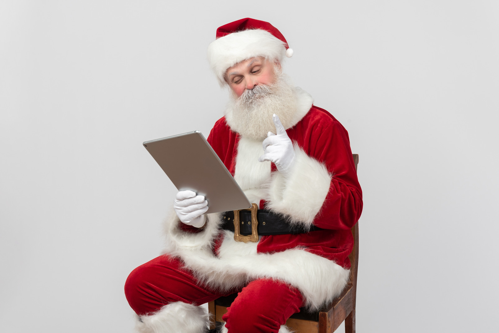 Sants claus reading something from the folder and pointing out