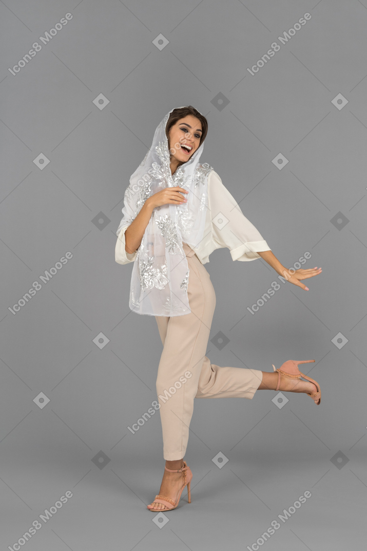 Excited young woman dancing alone