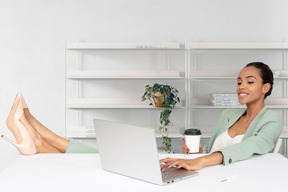 A woman sitting at a desk with a laptop