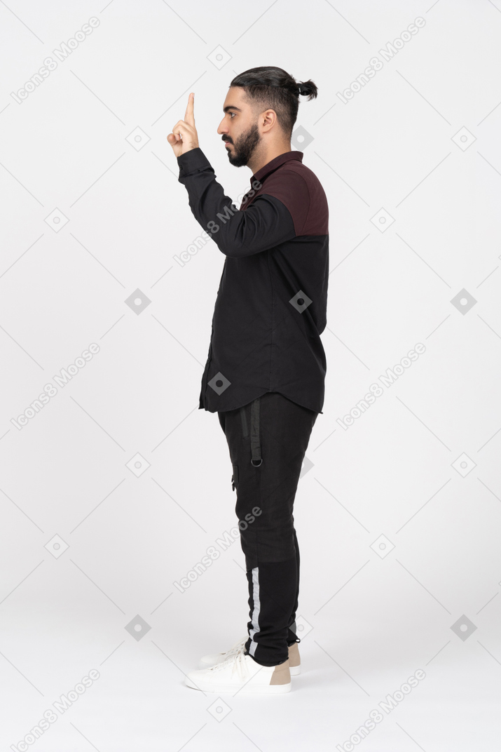 Side view of young man with peace gesture