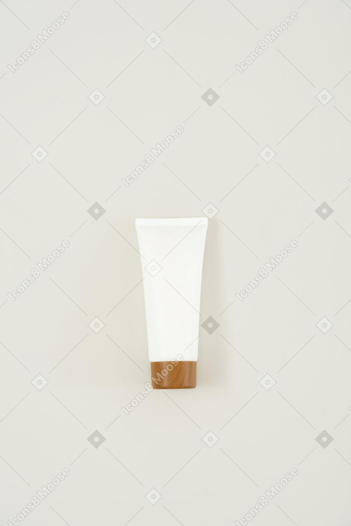 Cream tube with a brown cap