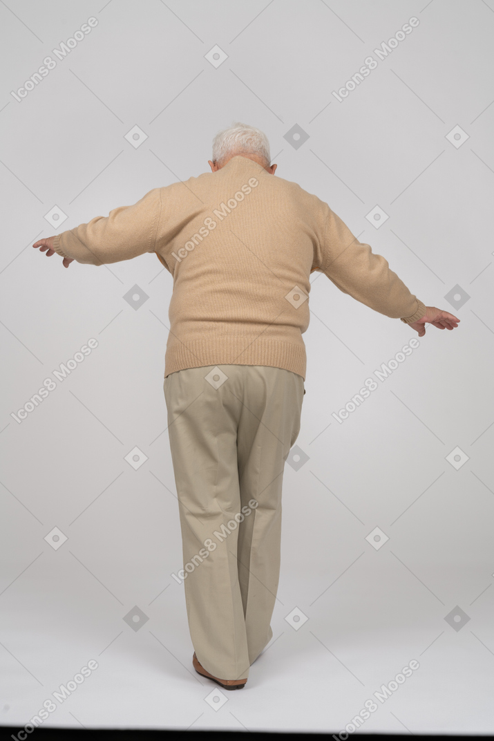 Vista trasera de un anciano con ropa informal caminando