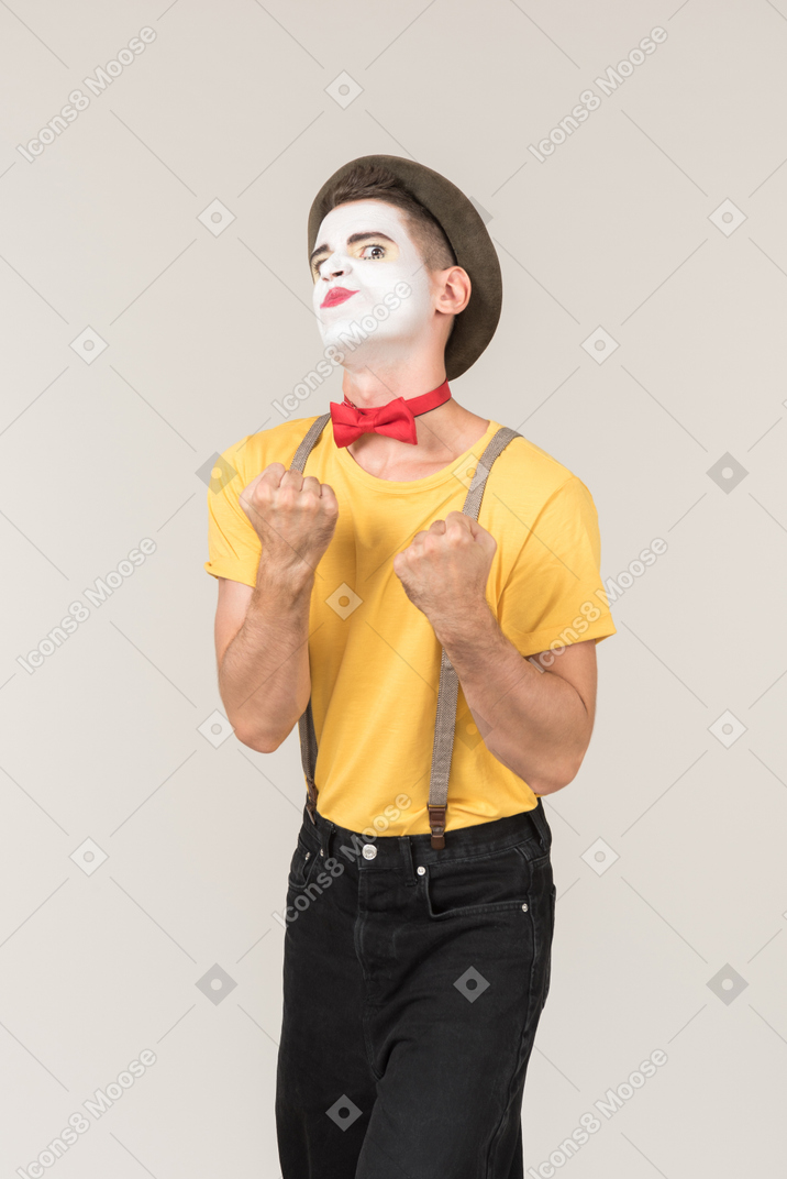 Male clown holding his fists up
