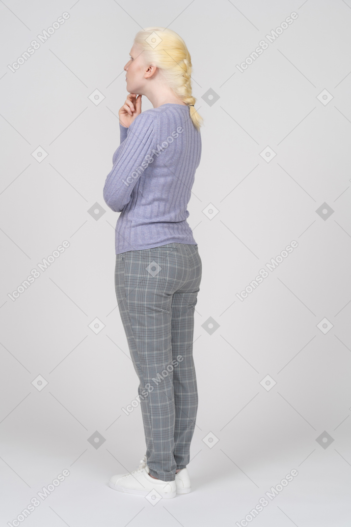 Back view of a woman touching her chin