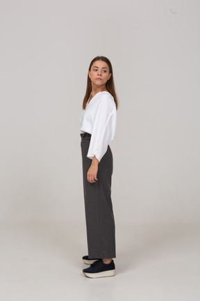 Side view of a young lady in office clothing looking to the left