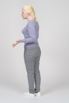 Rear view of young woman shrugging