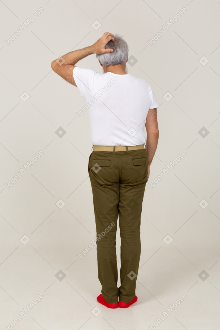Rear view of a man scratching his head