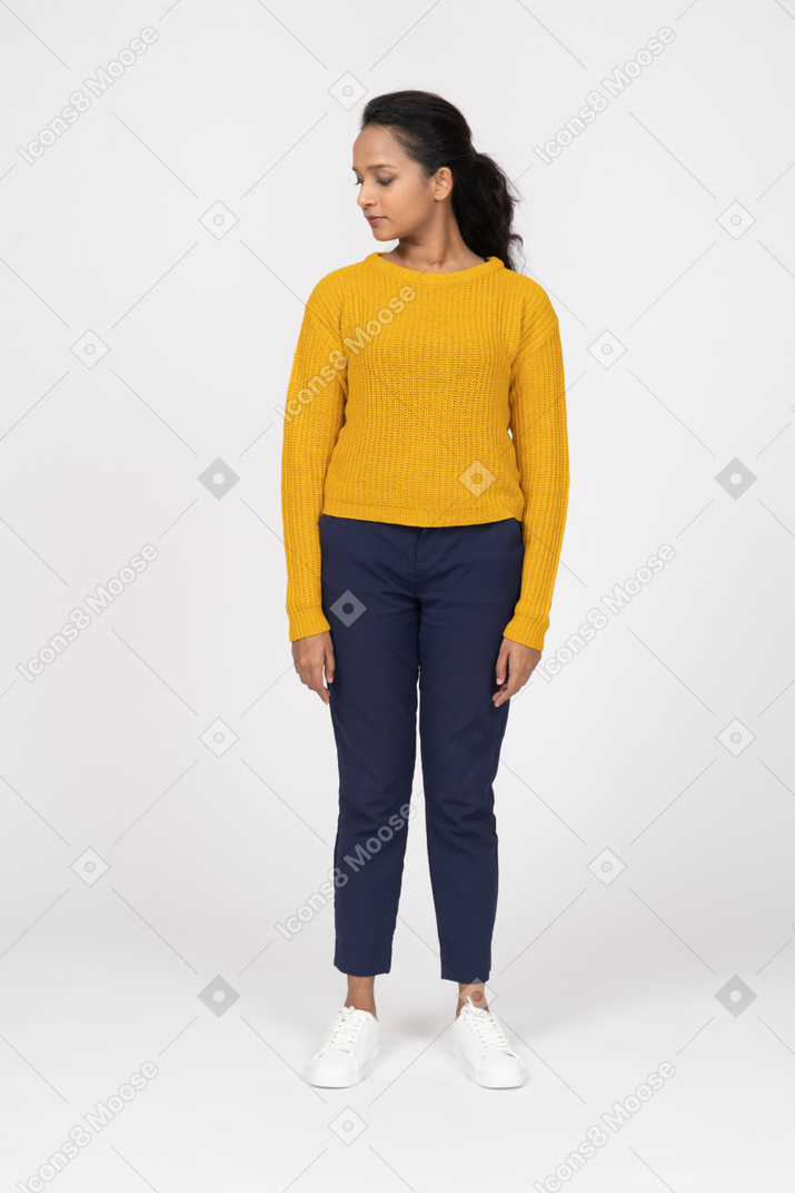 Front view of a girl in casual clothes looking down