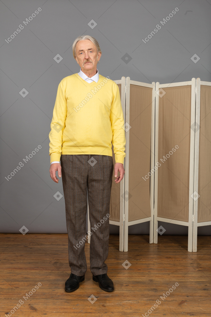 Front view of a serious old man looking at camera