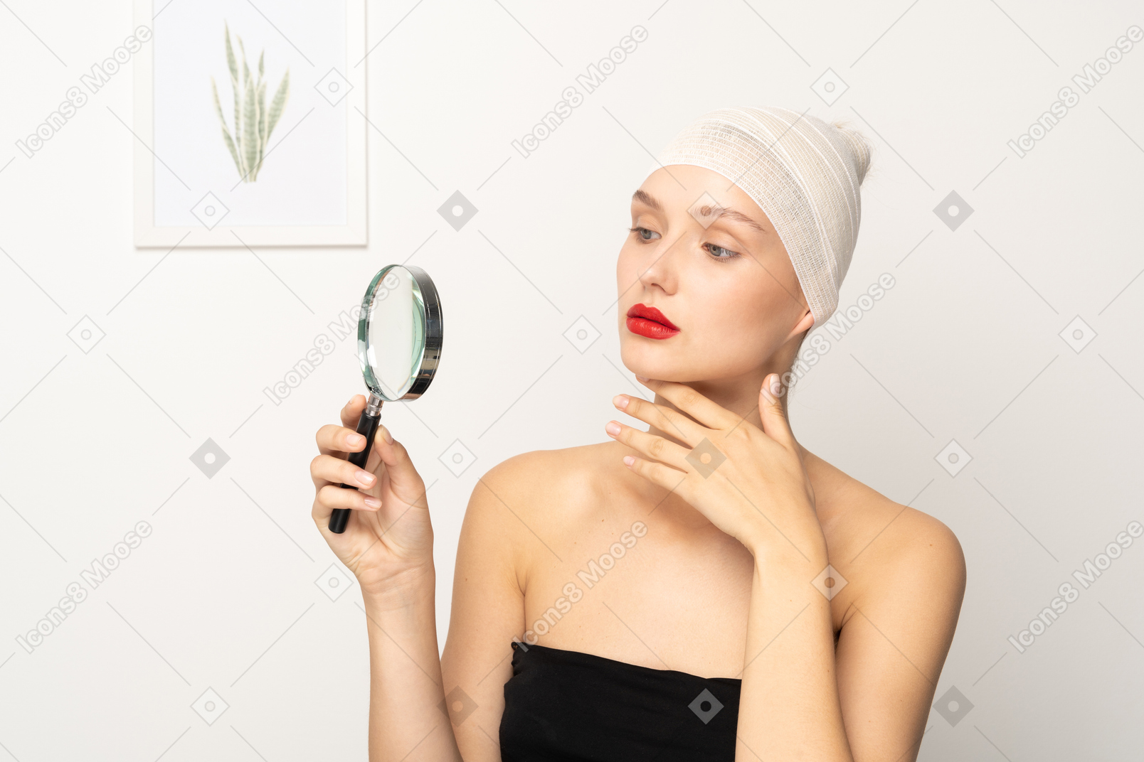 Young woman looking through magnifier and touching her chin