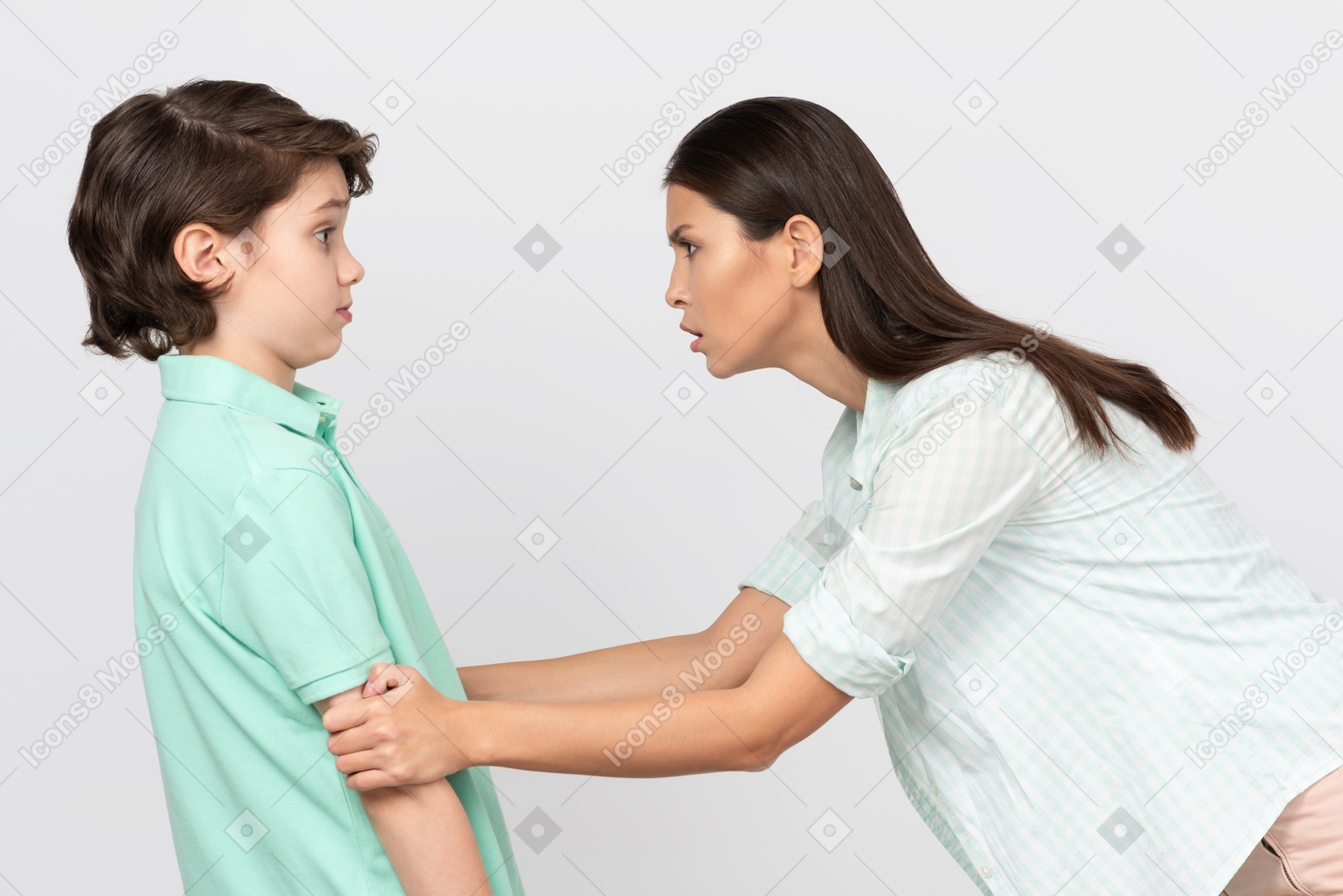 Angry mother grabbing her son's arms