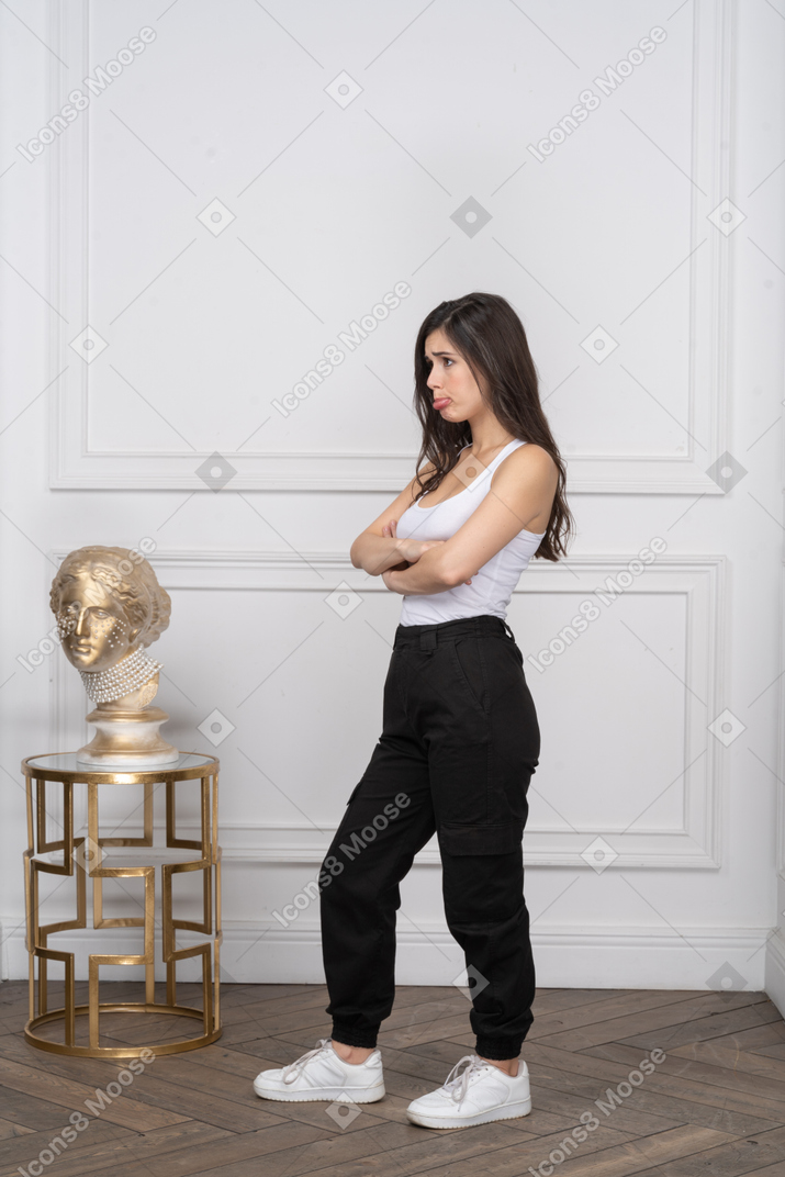 Young woman with her arms crossed looking upset