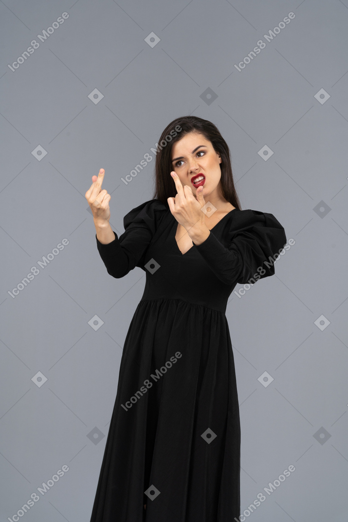 Three-quarter view of a mad young lady showing middle fingers