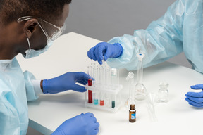 Two workers with tubes in laboratory