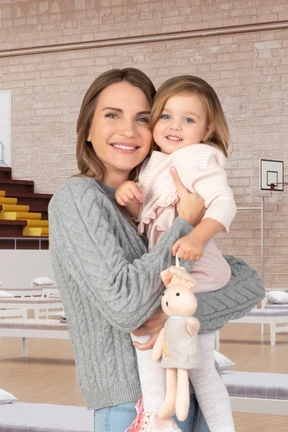 A woman holding a little girl in her arms