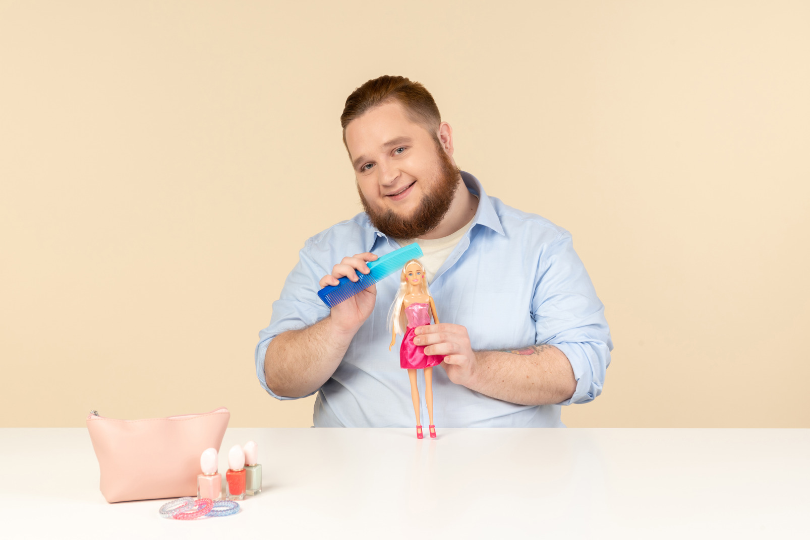 Big man holding hair brush and barbie doll