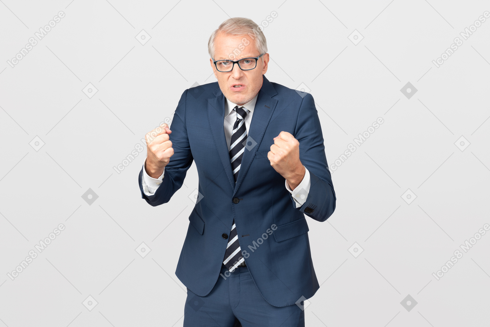Angry middle aged businessman holding his fists up