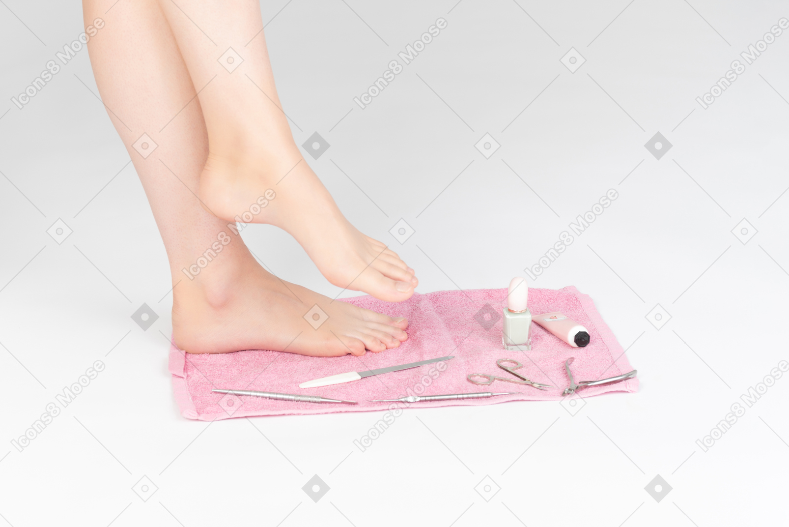 Shot of female legs and manicure tools near it