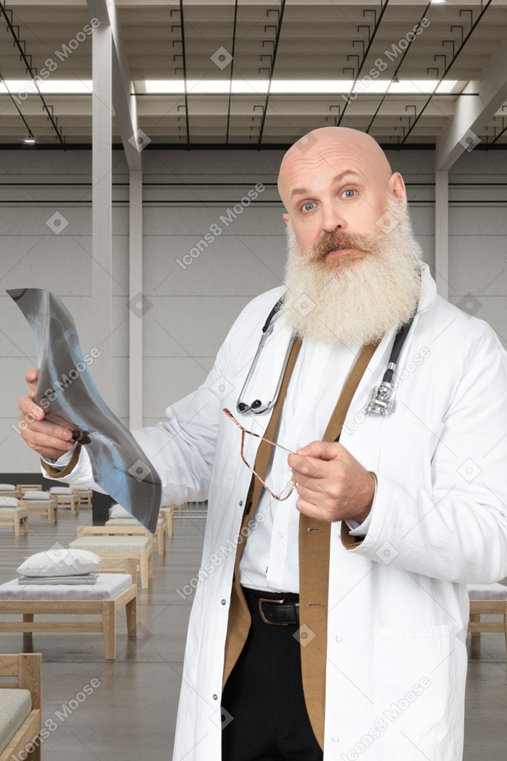 Man in a lab coat holding x-ray