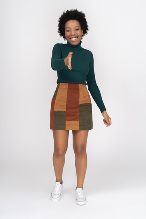 Smiling african girl standing with outstretched hand ready for handshake