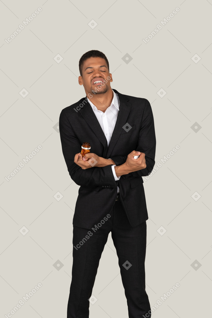 Angry looking african american man in blakc suit holding pills