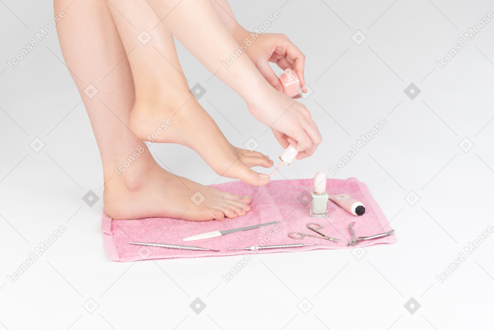 Shot of female legs and manicure tools near it