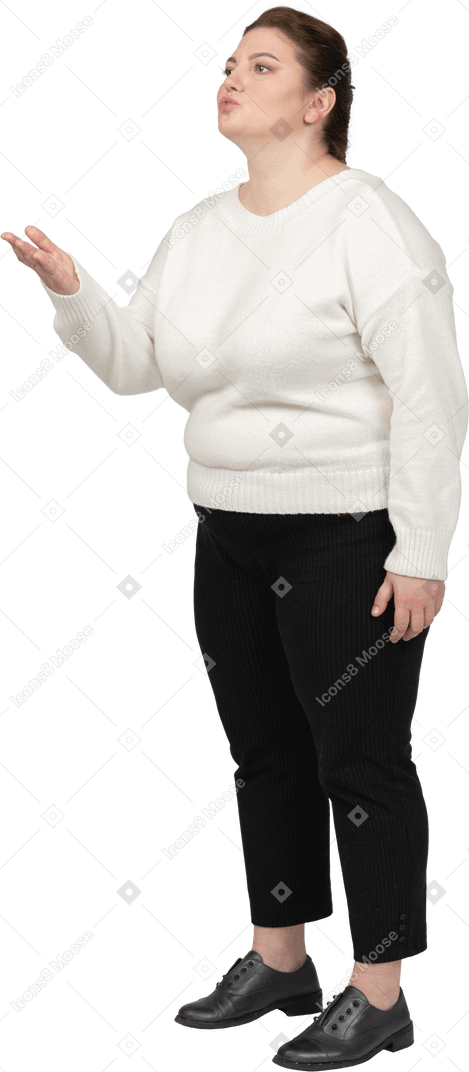 Plump woman in casual clothes blowing a kiss