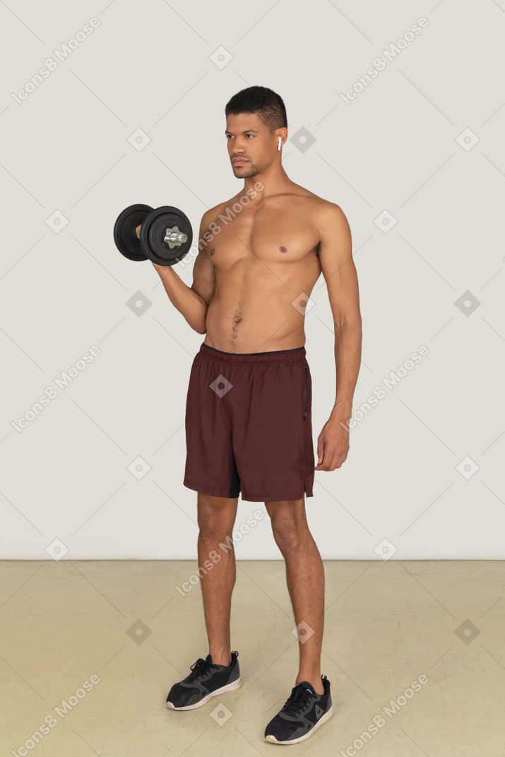 A three quarter side view of the handsome athletic man doing exercises