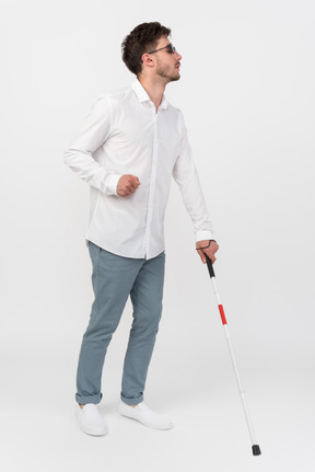 Blind man using a white cane