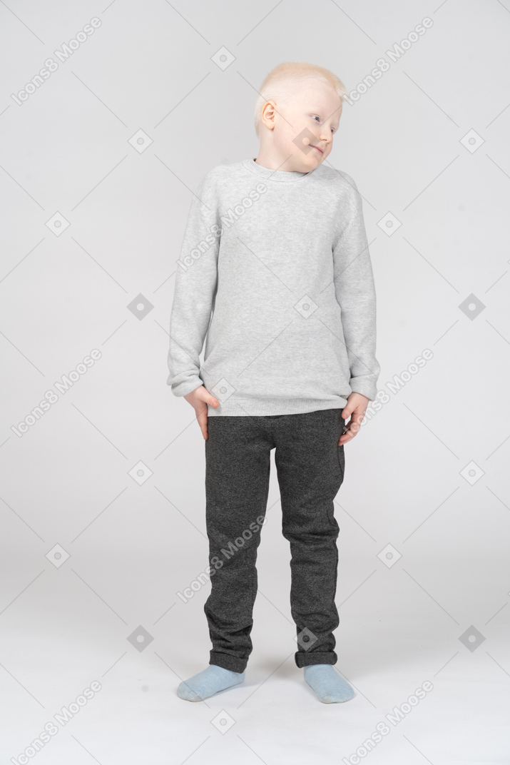 Little boy standing and looking aside
