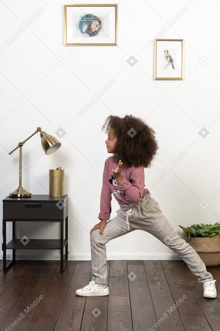 Cute girl kid posing on the apartments background