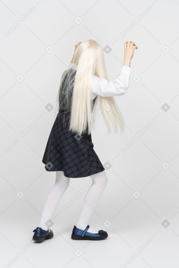 Back view of a schoolgirl trying to be scary