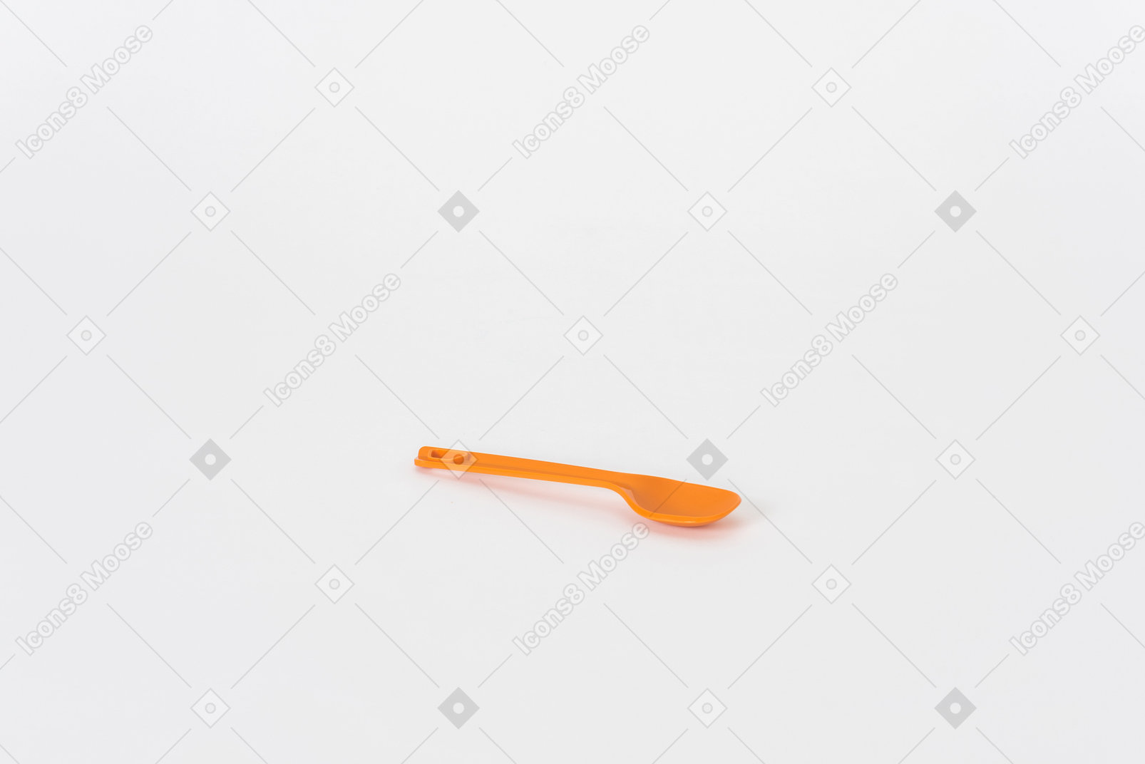 Plastic orange spoon on a white background