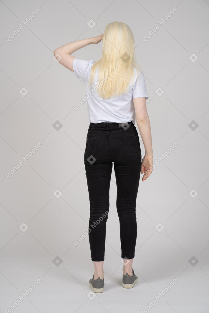 Back view of a long-haired woman giving a salute