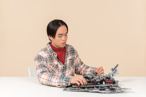 An asian geek guy in a checkered shirt