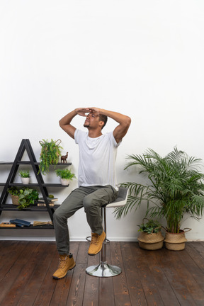 Good looking young man sitting on a chair